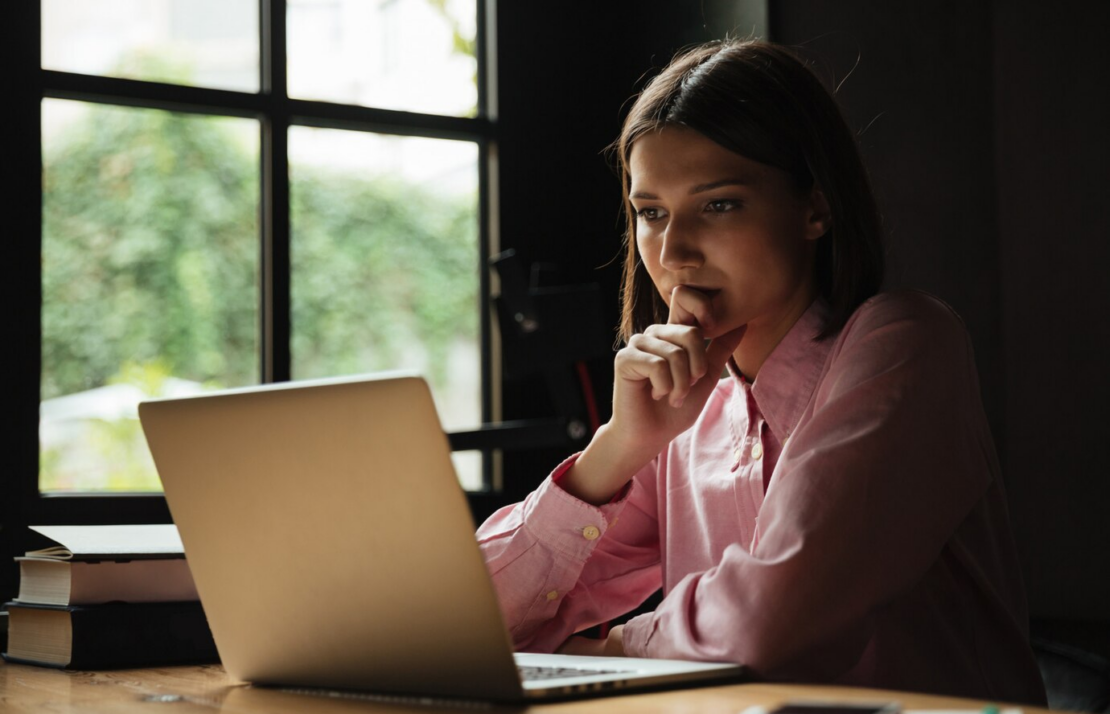 a life coach sitting Infront of pc and learning the life coaching course
